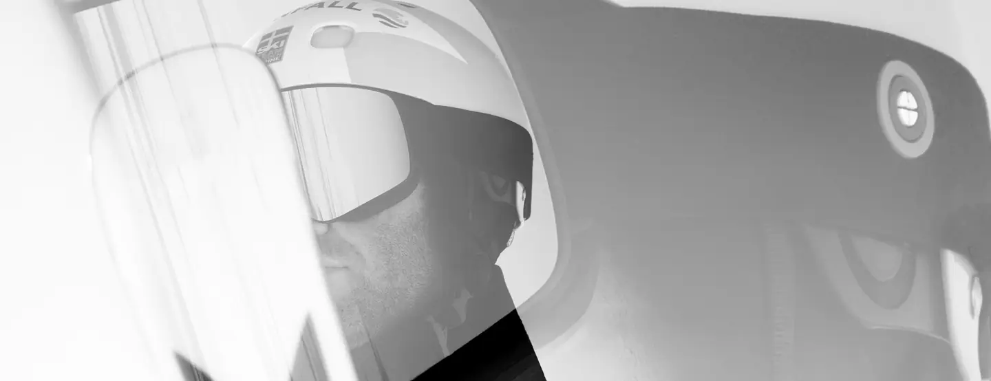 Close-up of a ski racer's helmet and goggles, in black and white